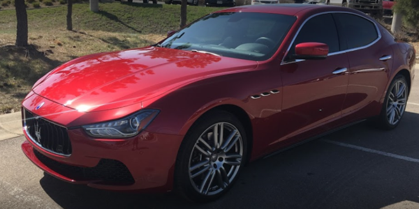 red mazerati with tinted windows