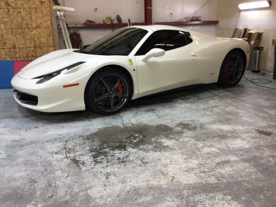 white ferrari sitting in garage