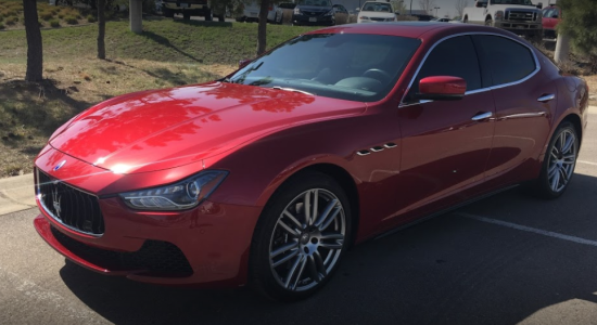 red mazerati with tinted windows